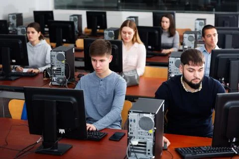 Group of people learning to use computers in classroom 스톡 사진