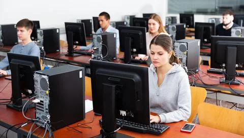 Group of people learning to use computers in classroom Stock Photos