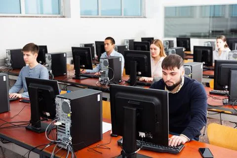 Group of people learning to use computers in classroom Stockfoto's