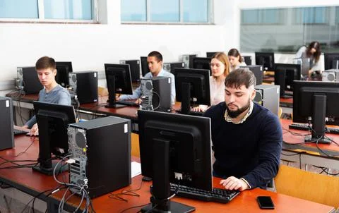 Group of people learning to use computers in classroom 写真素材