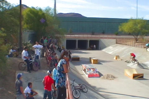 Group of people in local water way riding BMX doing tricks Stock Footage