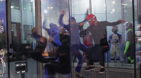 Group of people make flips inside fly station. Simulator skydiving. Contest Stock Footage 67558122