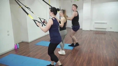 Group of people making the step forward lunge with T-Fly Stock Footage 73546496