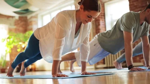 Group of people making yoga exercises in gym Stock Footage