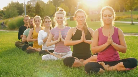 Group of people meditating at sunset Stock Footage 81157095