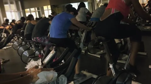 Group of people pedaling fast during a spinning class Stock Footage 54917231