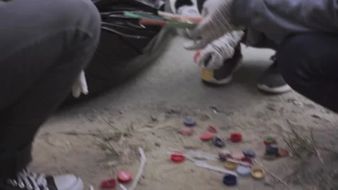 A group of people is picking up plastic waste on the road side. Stock Footage 153202953