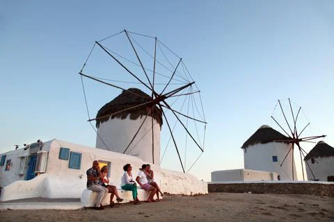 Group of people posing in front of a windmill Stock Photos