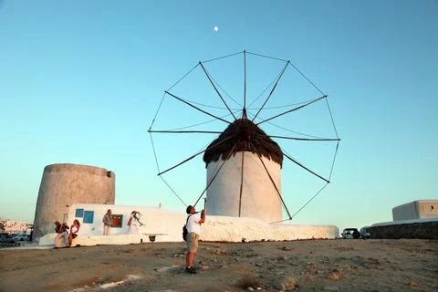 Group of people posing in front of a windmill Stock Photos