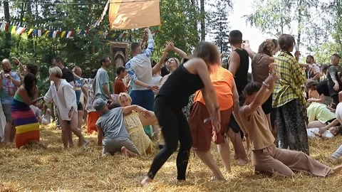 Group of people practices contact improvisation on straw in forest Stock Footage 323649038