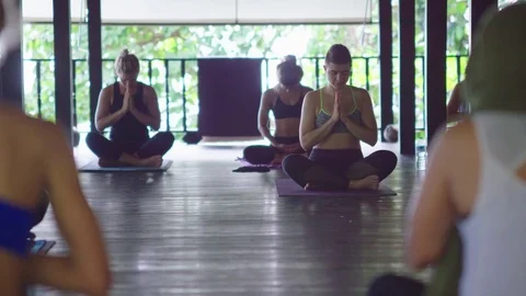 Group of people practicing lotus position in gazebo near the sea Stock Footage 74778994