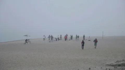 Group of people practicing yoga on the beach Stock Footage 73190933