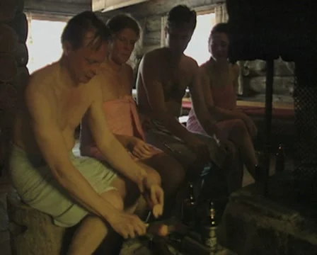 A group of people prepare to cook food after a sauna Stock Footage