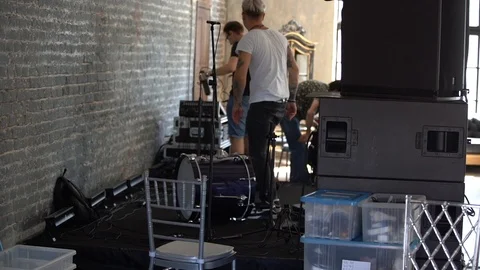 A group of people preparing for a musical performance, connects equipment Stock Footage 103469688