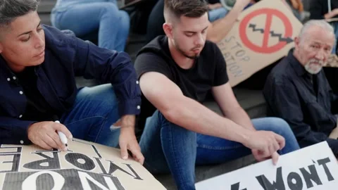 Group of people preparing protest sign cartels for financial crisis and global   Stock Footage 239335422