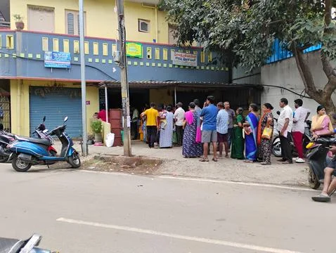 Group of people in a queue to purchase ration in the ration dept at Devinag.. Foto stock