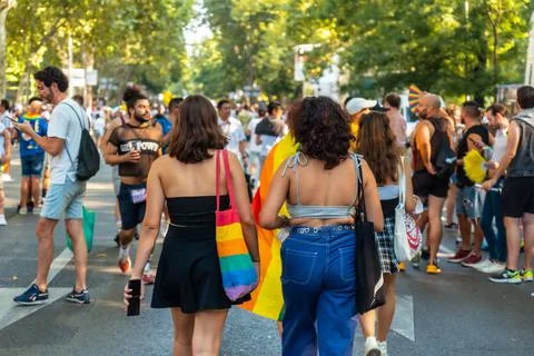 Group of people with rainbow flags taking part at the 2022 pride parade in Stock-Fotos