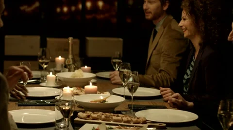 Group of people raising glasses to make a toast at a dinner party. Stock Footage 61157754