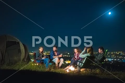 The group of people rest on the nature and make a barbecue. Wide angle Stock Photos