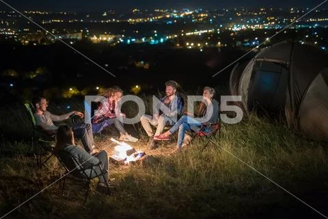 The group of people rest on the nature and make a barbecue. Wide angle Stock Photos