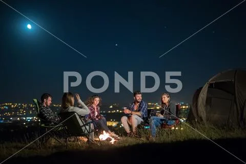 The group of people rest on the nature and make a barbecue. Wide angle Stock Photos