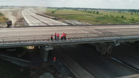 A group of people at a road junction under construction. Aerial view. People Stock Footage 137945289