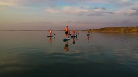 Group of people rowing simultaneously on EPS boards Stock Footage 135262967