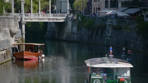 Group of people rowing on the SUP board on Ljubljanica river Stock Footage 162252901