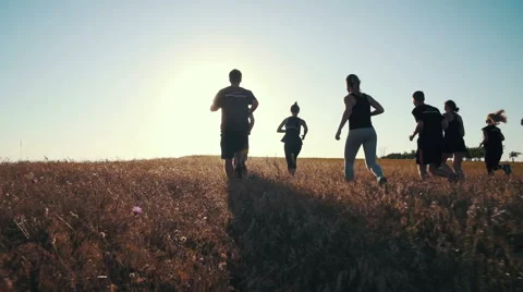 Group of people running on a field in Stock Video Pond5