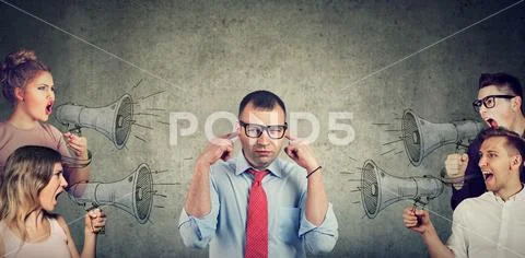 Group of people screaming in megaphones at annoyed businessman Stock Photos