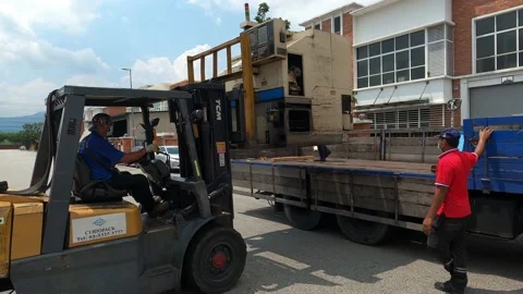 A group of people set up a machine at lorry for transfer Stock Footage 158687049