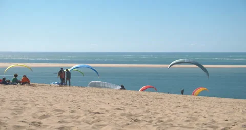 A group of people on the shore of the beach preparing to practice Stock Footage 158920861