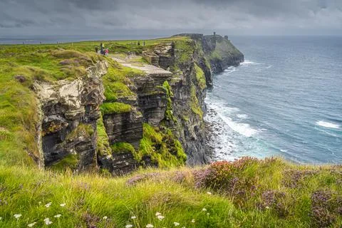 Group of people sightseeing iconic Cliffs of Moher, Ireland Stock Photos