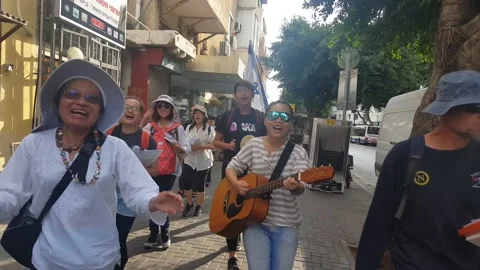 Group of people singing and dancing along the street in Tel Aviv 20161115 140149 Stock Footage 134038662