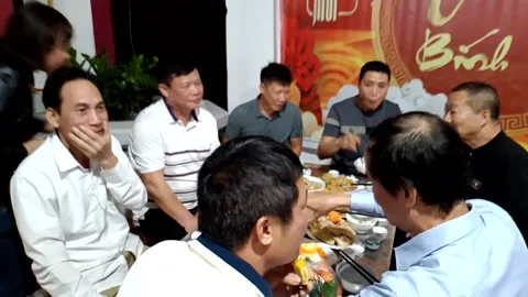 A group of people singing and dancing during a family reunion meal Stock Footage 327270509