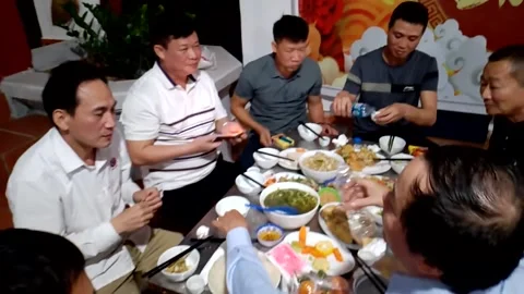 A group of people singing and dancing during a family reunion meal Video stock 327270535