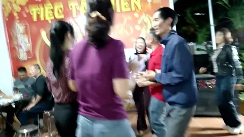 A group of people singing and dancing during a family reunion meal Stock Footage 327271161