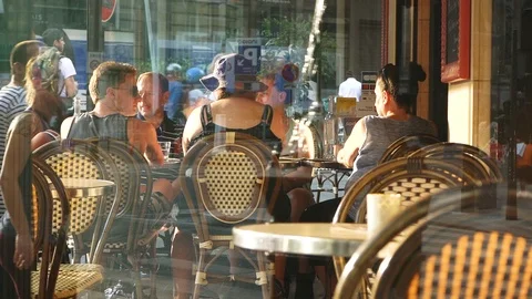 Group of People Sit by Table of Cozy Street Cafe Stock Footage 116834501