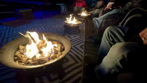 Group of people sitting around propane fire pits while camping 스톡 동영상 299762452