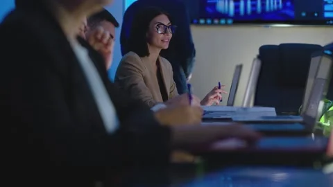 Group of people sitting inside office or conference room and working discussing Stock Footage 213618132