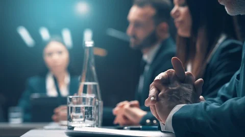 The group of people sitting at the table and discuss business plan Stock Footage 126085272