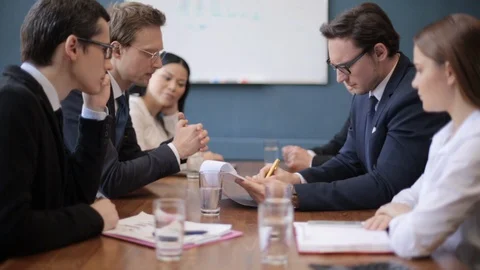 A group of people sitting at a table Stock Footage 130047231