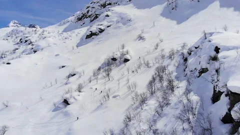 Group of people skiing down the mountain valley. Epic free ride scene. Stock Footage 150554444