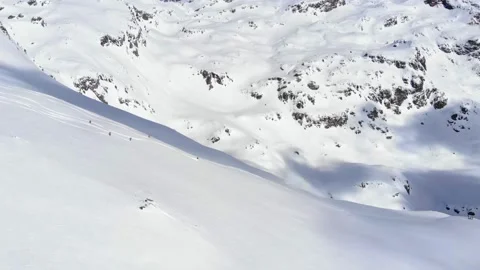 Group of people skiing down the mountain valley. Epic free ride scene. Stock Footage 150554523