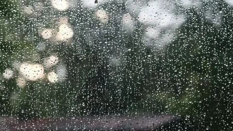 A group of people standing in the rain 스톡 동영상 157867727