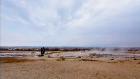 A group of people standing on top of a sandy beach Stock Footage 156016478