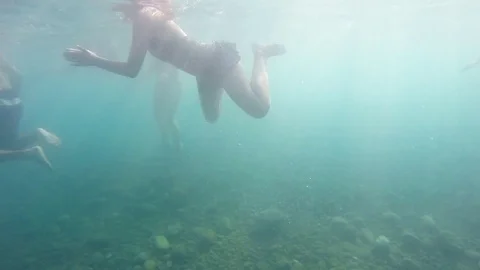 Group of people swimming in sea or ocean during summer vacation. Underwater Stock Footage 81821053