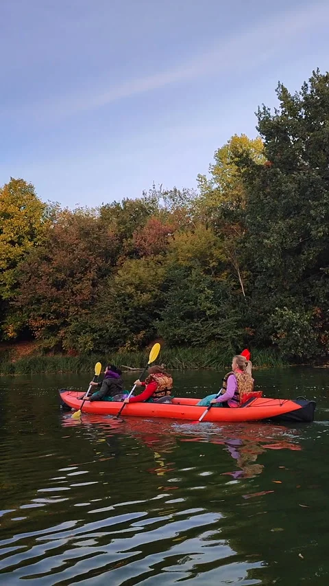 Group people three sitting inflatable boat rowing oar floating river Vertical Stock Footage 295171340