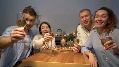 A group of people toasting and drinking champagne at home. Stock Footage 167648030