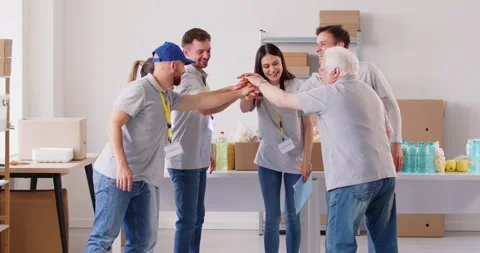 A group of people in uniform raise their hands, a gesture of teamwork Stock Footage 281325229